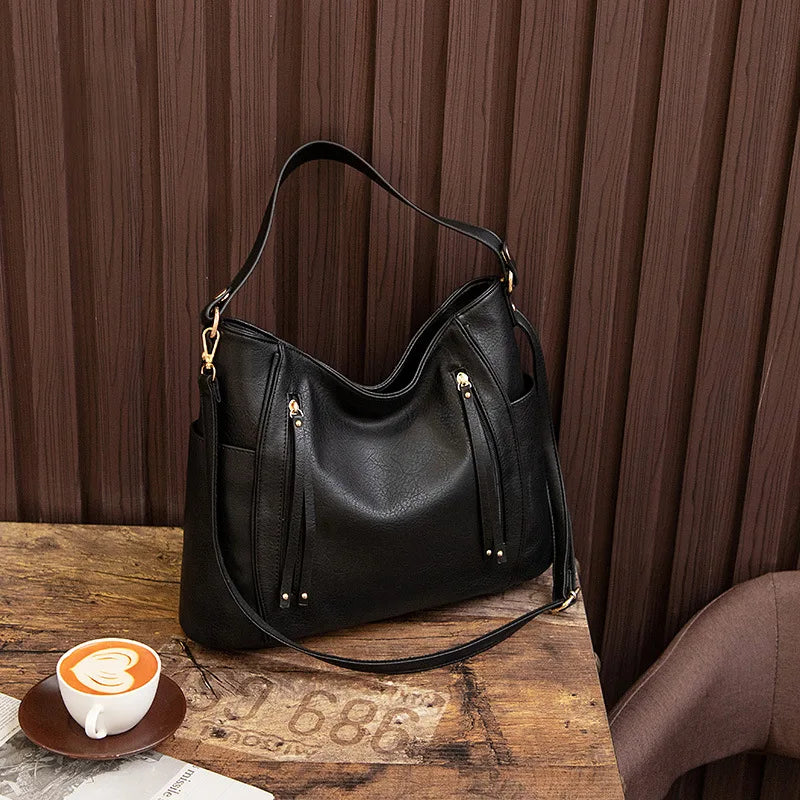 Coralie™ | Usnjena torba s fru-fruji