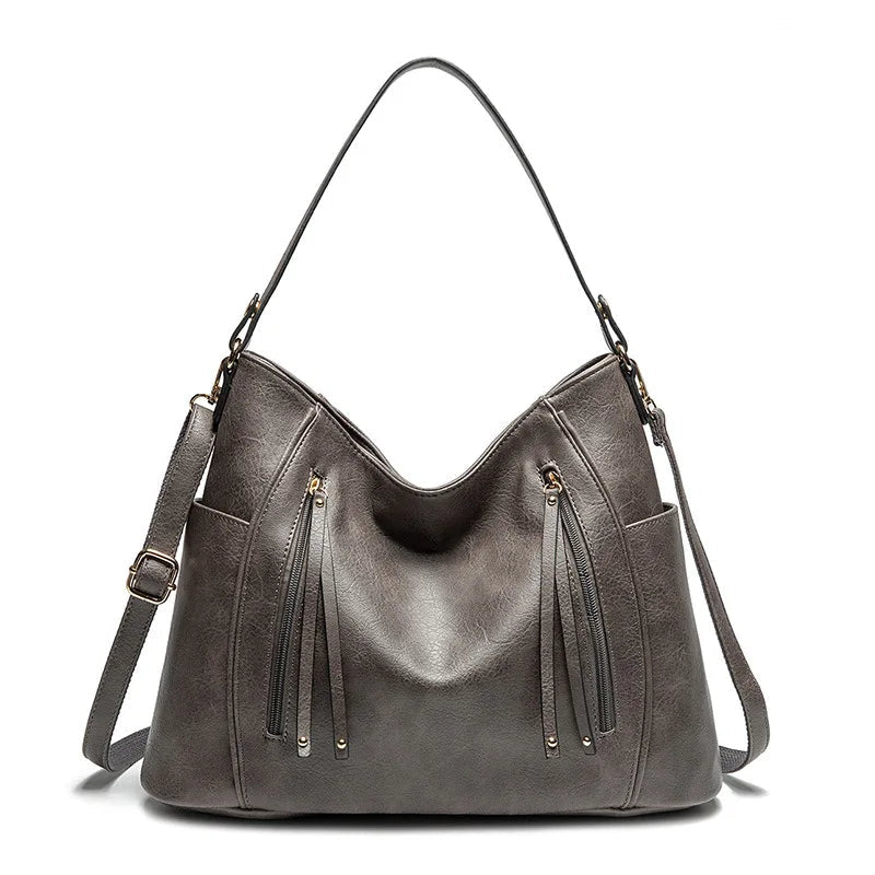 Coralie™ | Usnjena torba s fru-fruji